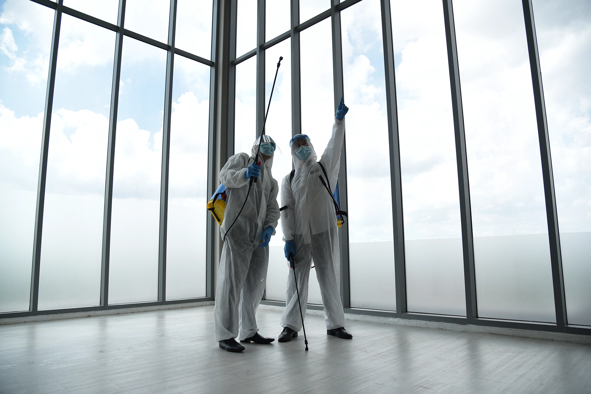 Professional workers carrying out specialist cleaning inside an enclosed facility area